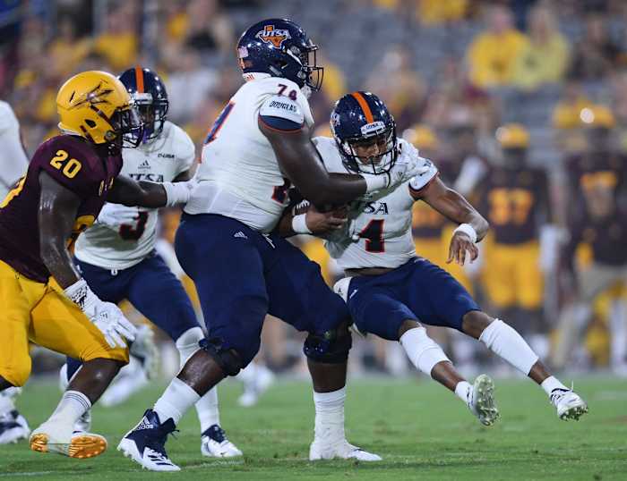 Sep 1, 2018; Tempe, AZ, USA; UTSA Roadrunners quarterback Cordale Grundy (14) runs into UTSA offensive lineman Spencer Burford (74) during the first half against the Arizona State Sun Devils at Sun Devil Stadium.